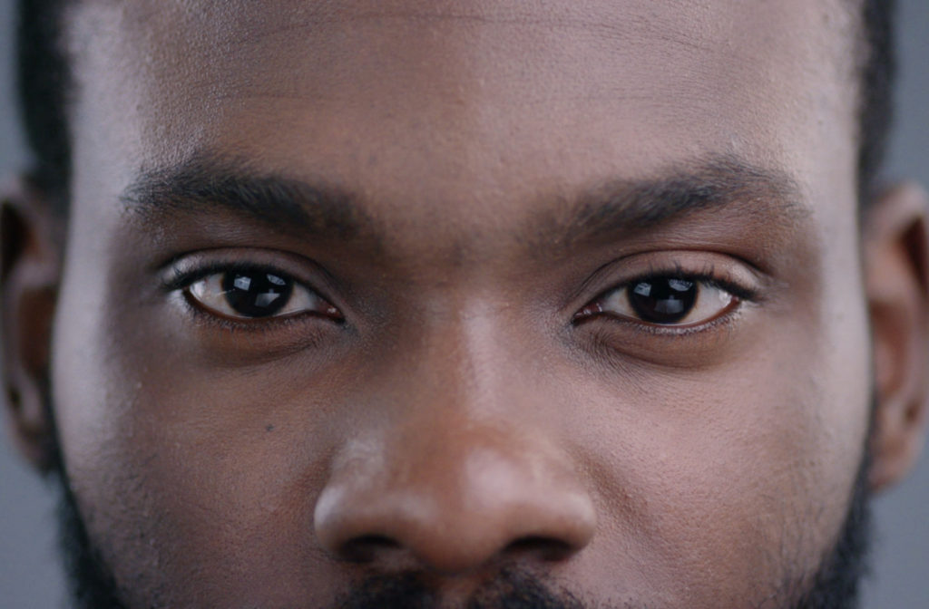 A close-up of a man's face with a pair of clean and healthy eyelids.