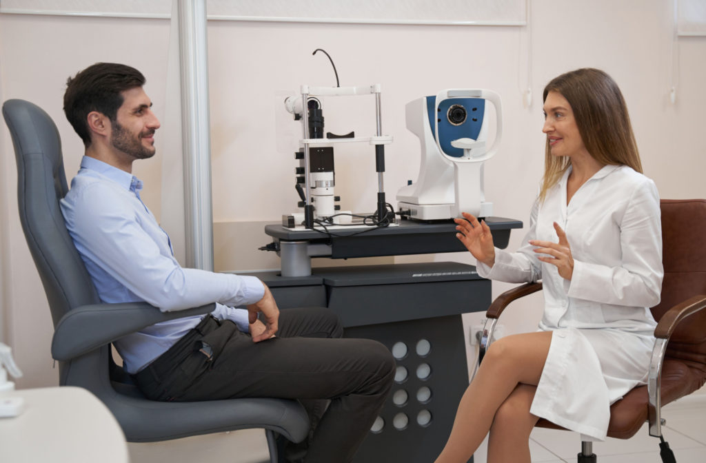 An optometrist talking to her patient in her clinic.