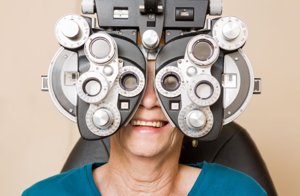 A woman is getting her eyes examined for her peripheral vision.