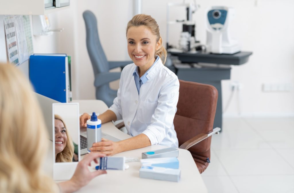 An optometrist goes over proper contact lens wear and care with their patient during their annual contact lens fitting.