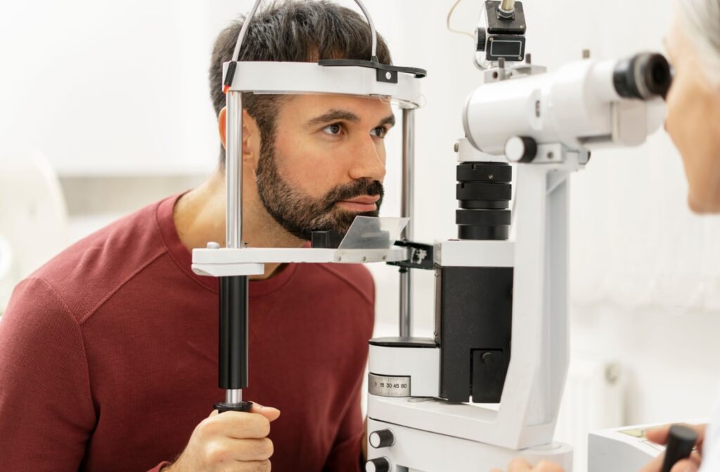 An adult gets an eye exam to determine whether they're able to get contact lenses with their astigmatism.