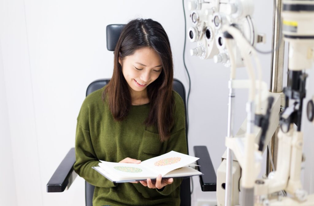 A woman at the eye doctor going through a color vision test.