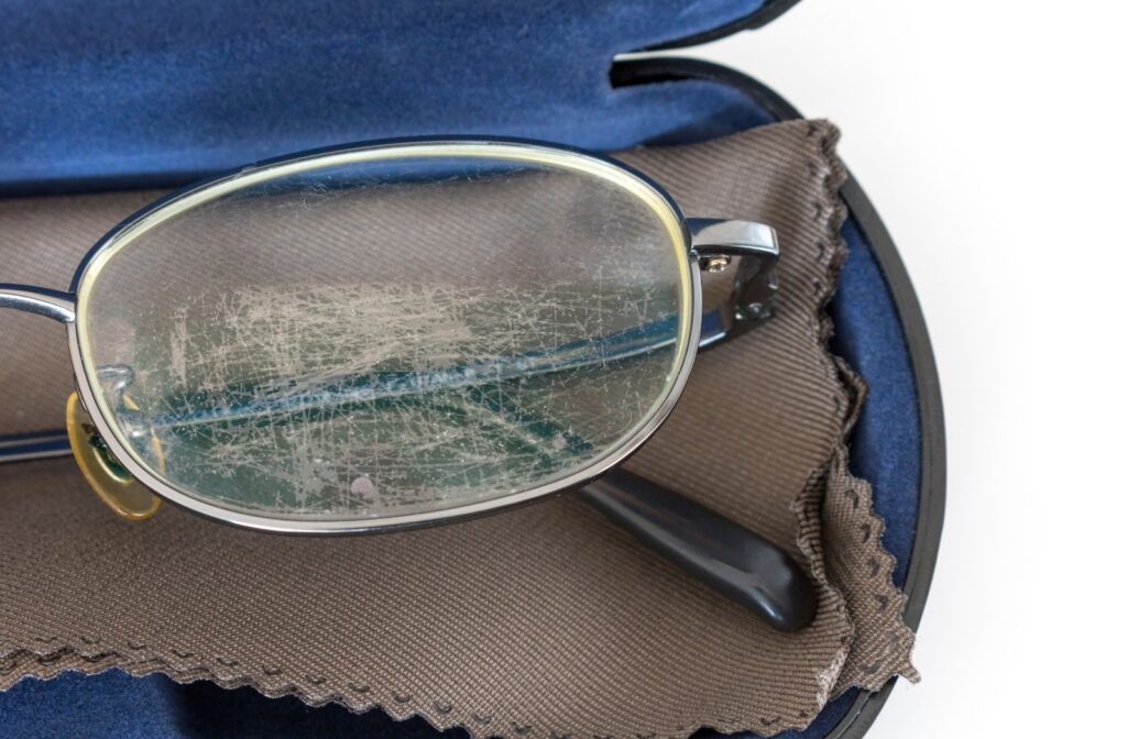 A close up of scratches lenses in a pair of eyeglasses.