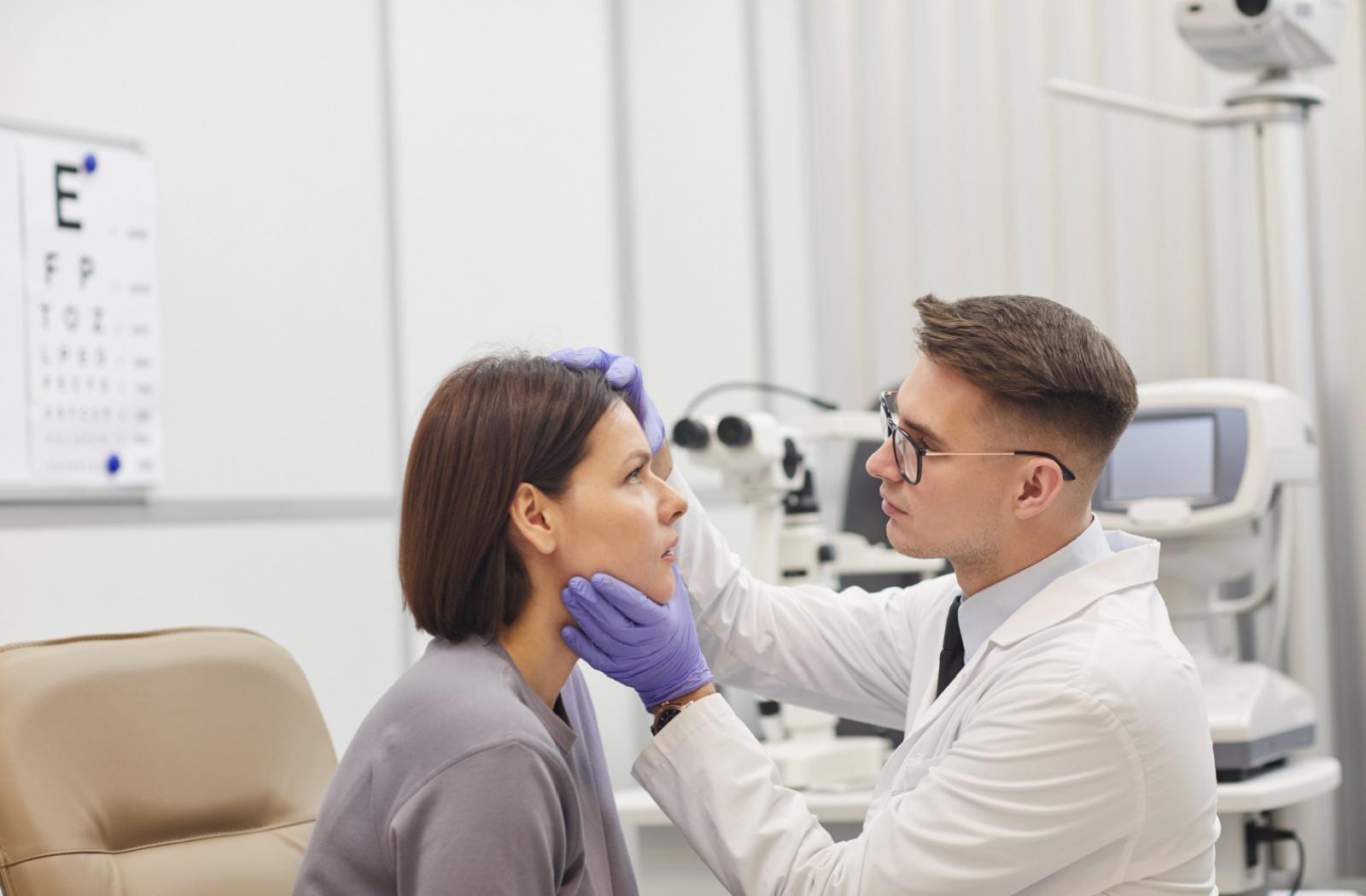 A patient with pink eye having their eyes examined and treated by an optometrist.